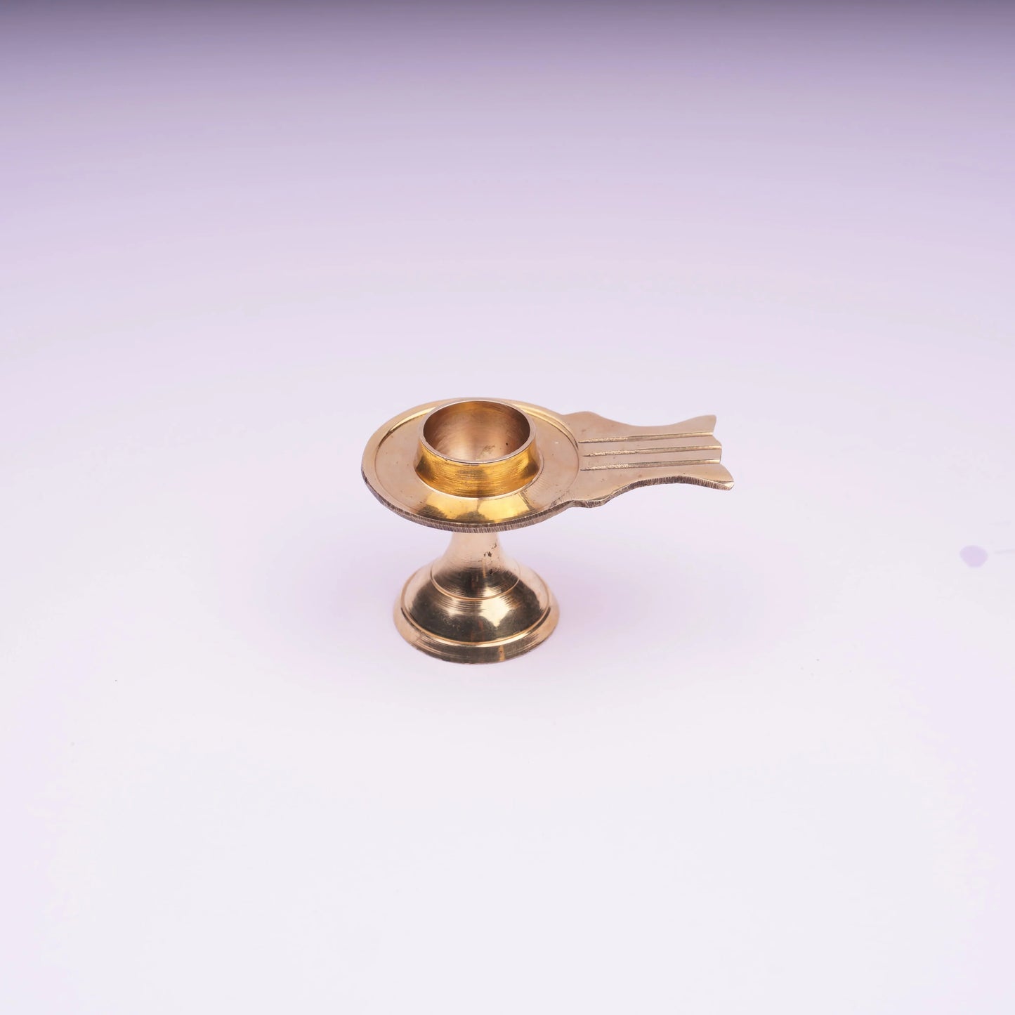 Brass oil lamp with pedestal base on white background, traditional decor item