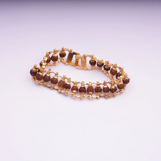 Gold chain bracelet with brown stone beads on white background