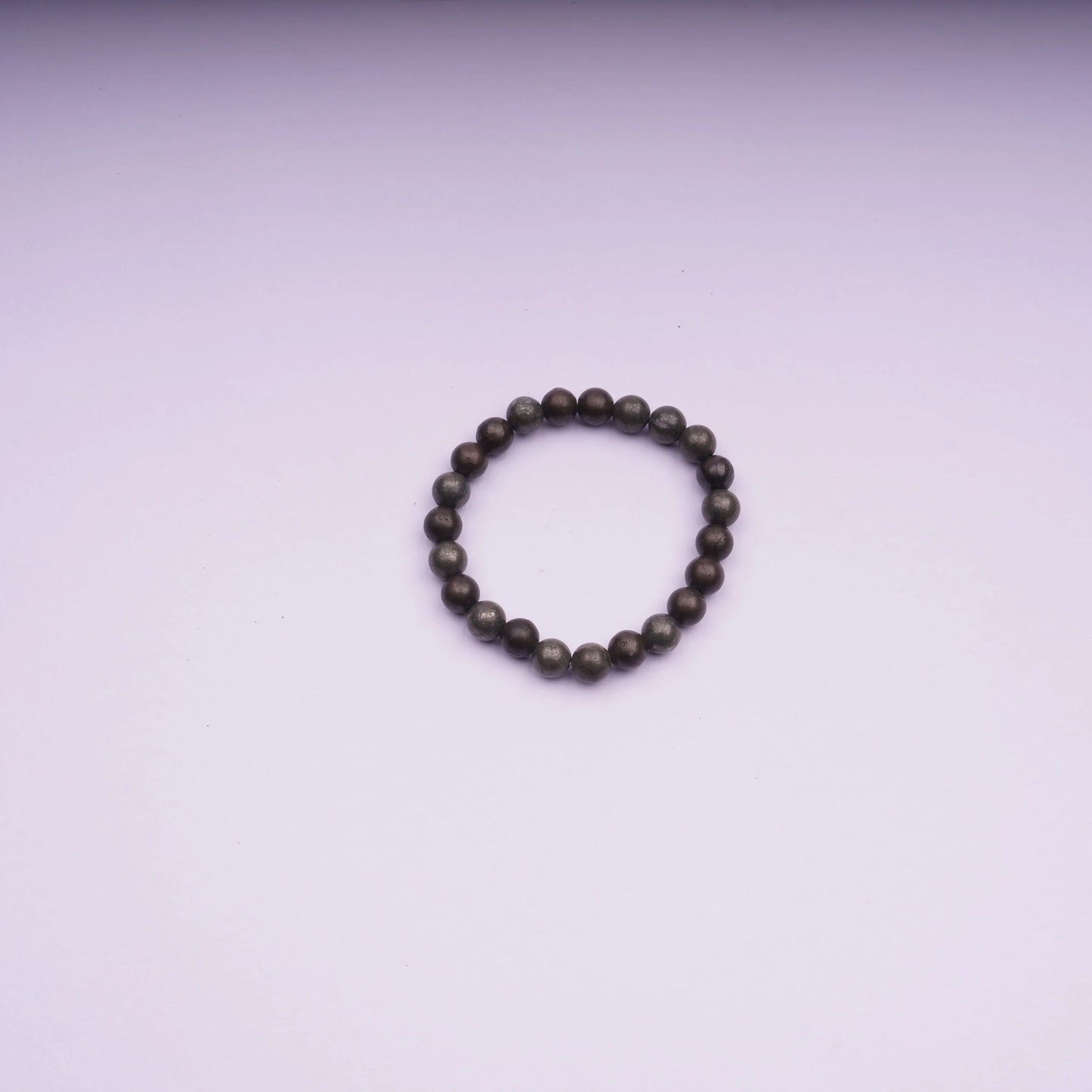 Round stone bead bracelet on light pink background, minimalist jewelry product photo