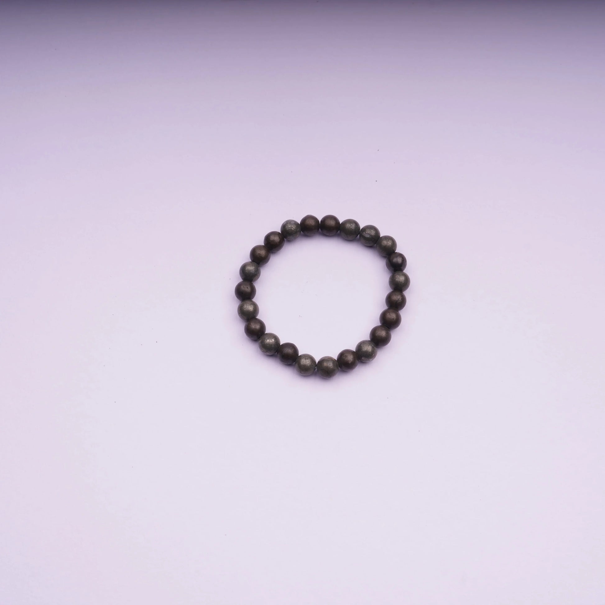 Round stone bead bracelet on light pink background, minimalist jewelry product photo