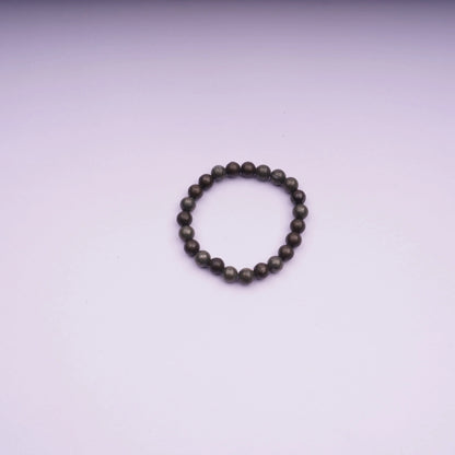 Round stone bead bracelet on light pink background, minimalist jewelry product photo