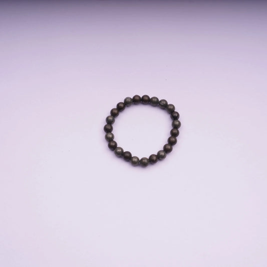 Round stone bead bracelet on light pink background, minimalist jewelry product photo